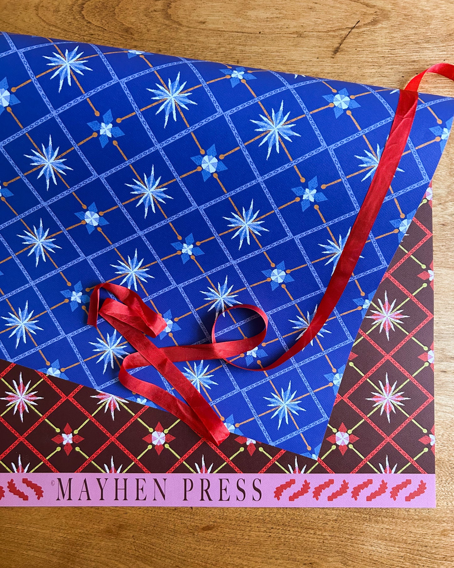 double sided stars and diamonds patterned crafting paper on wooden background