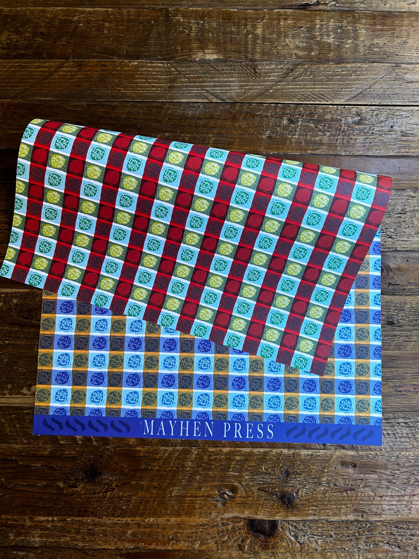 double sided wrapping paper sheet featuring a blue colorway on one side and red on the other with a dots and stripes pattern