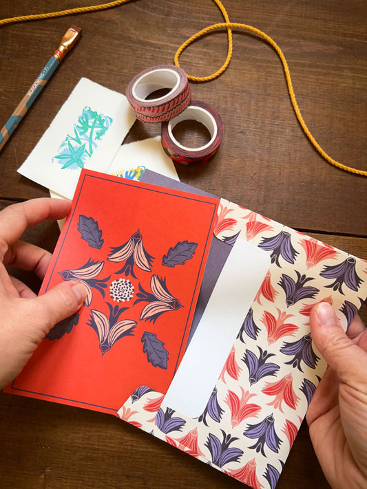 Hand sliding letter into envelope