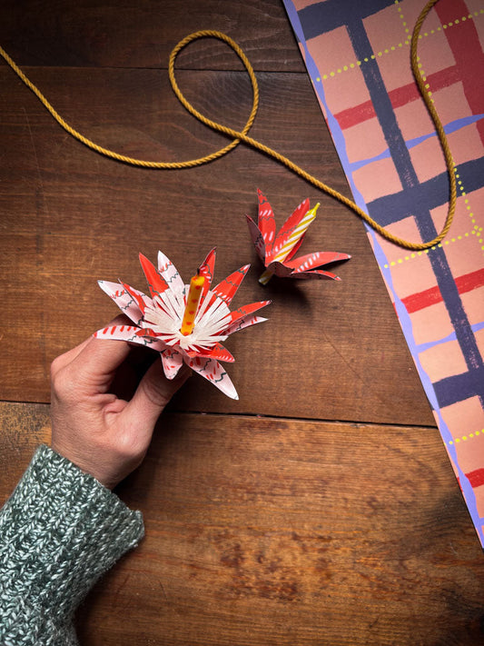 hand holding paper flower birthday candle holder
