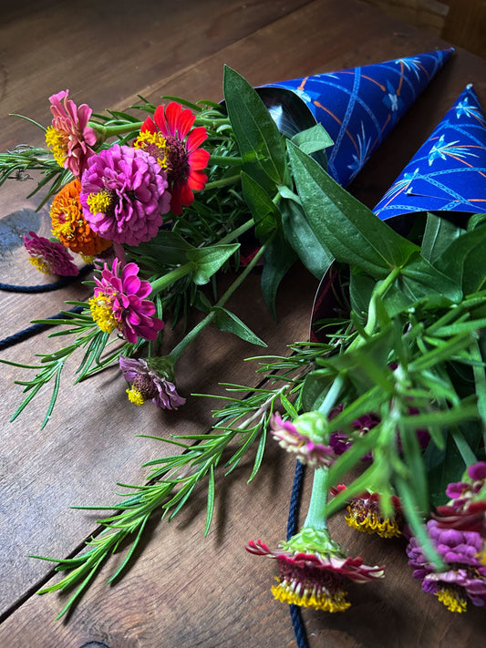 zinnias in a paper flower cone