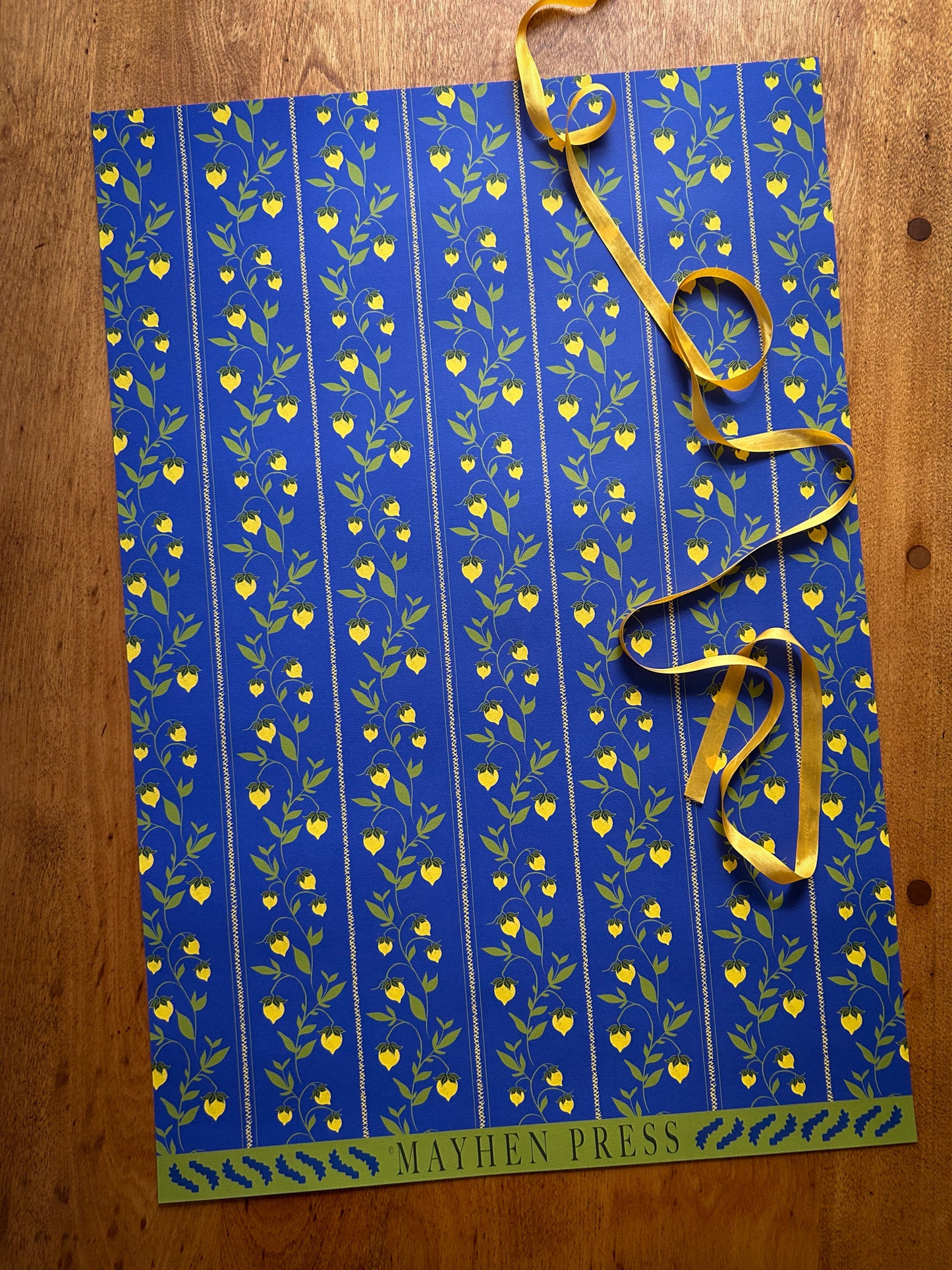 berry vine patterned wrapping and crafting paper featuring yellow berries on a blue background