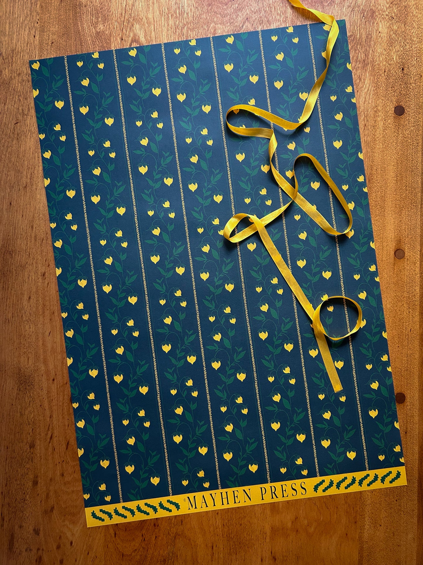 berry vine patterned wrapping and crafting paper featuring yellow berries on a dark green background