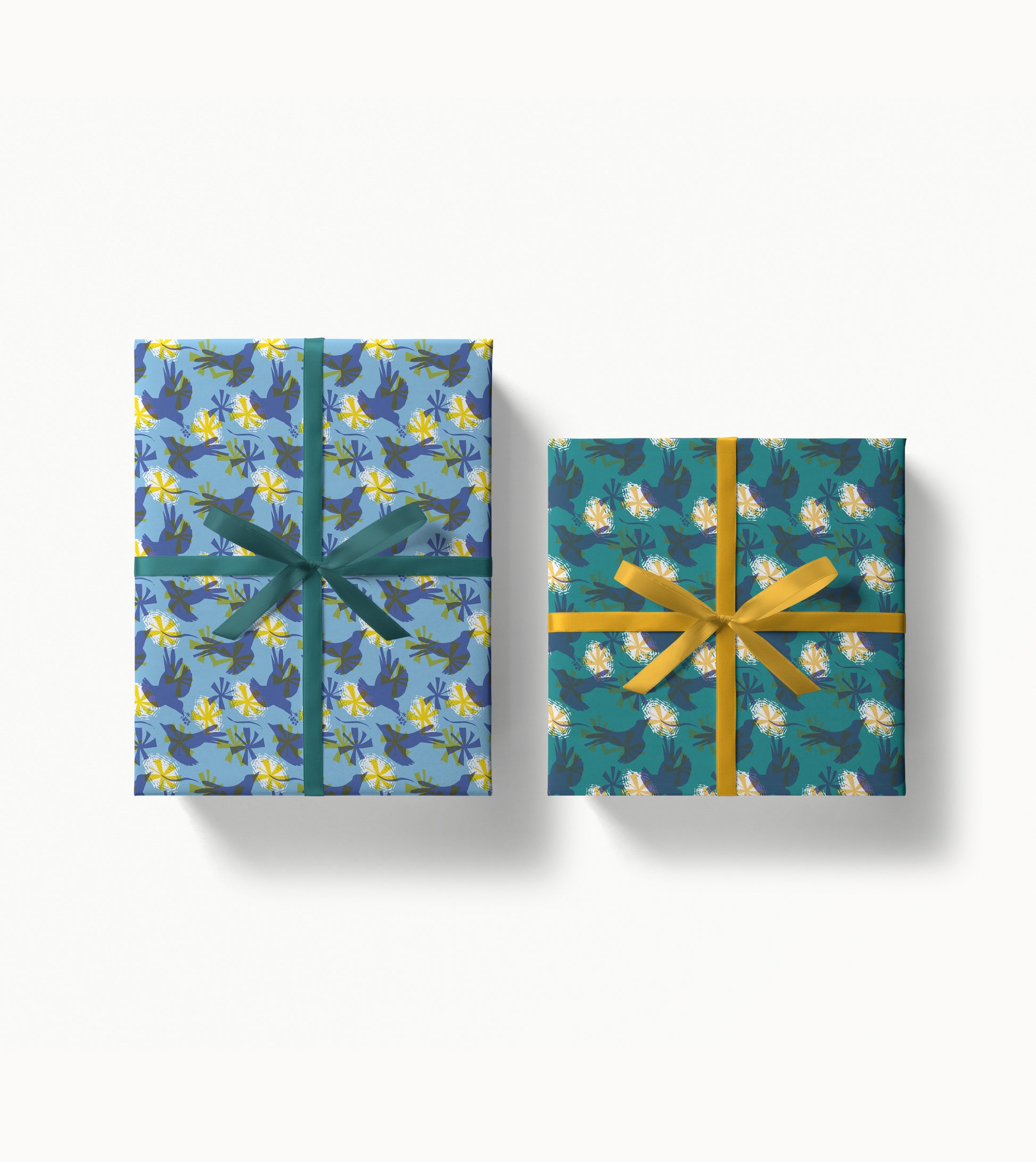 Two wrapped gift boxes with decorative patterned paper and ribbons on a white background
