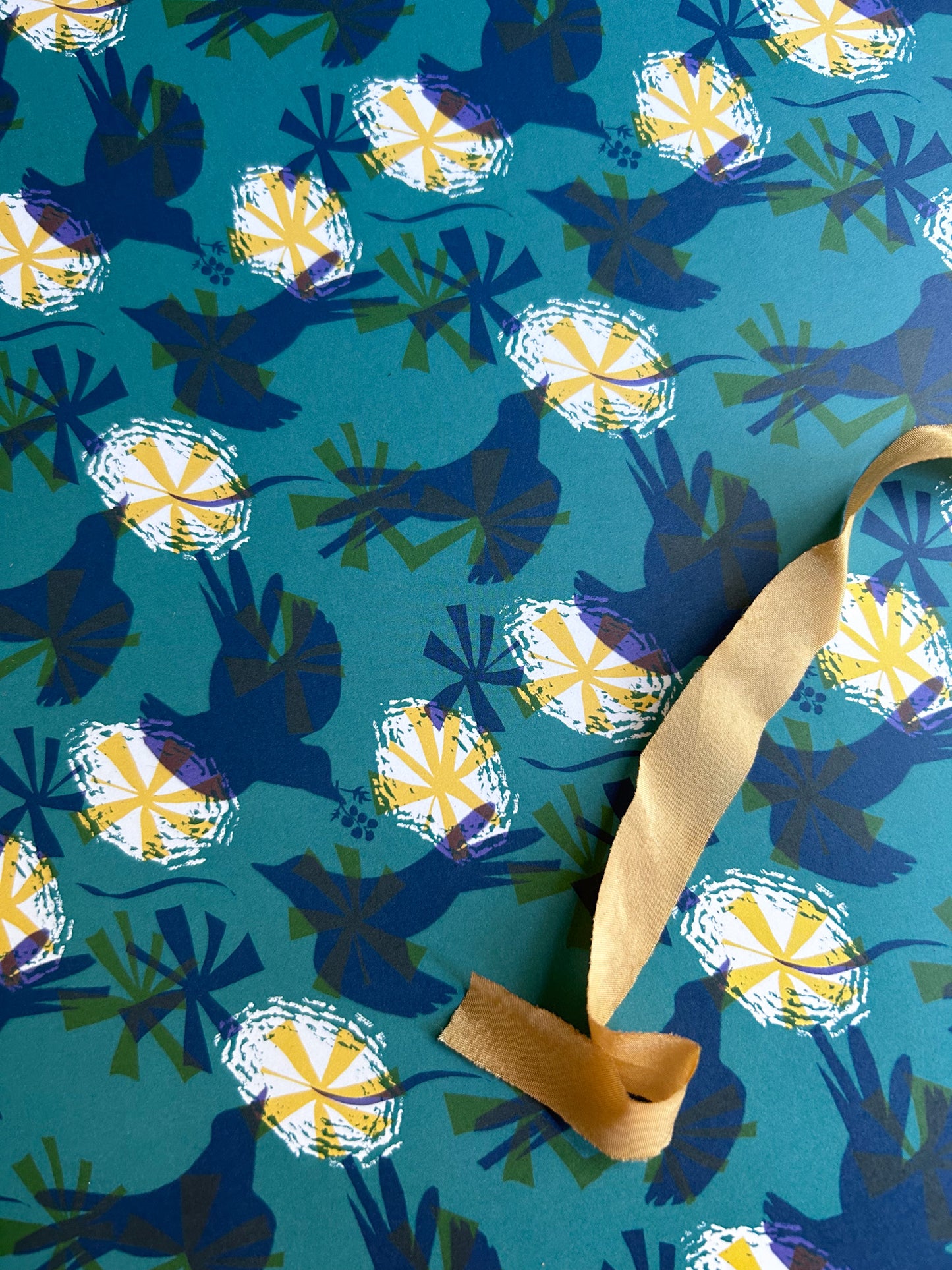 close up of dark green bird patterned wrapping paper