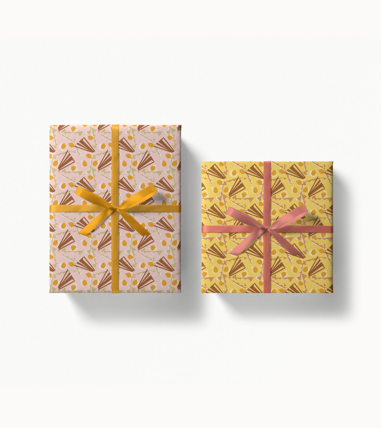 Two gift boxes with unique patterned wrapping paper and ribbons on a white background