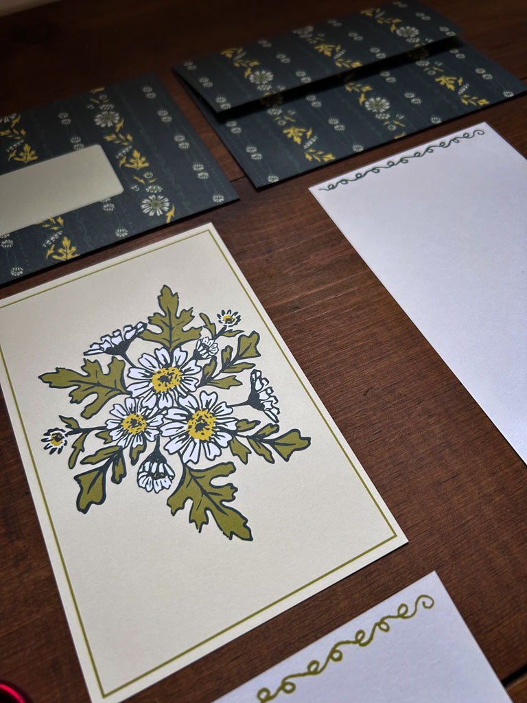 Floral card with matching patterned envelope on a wooden surface