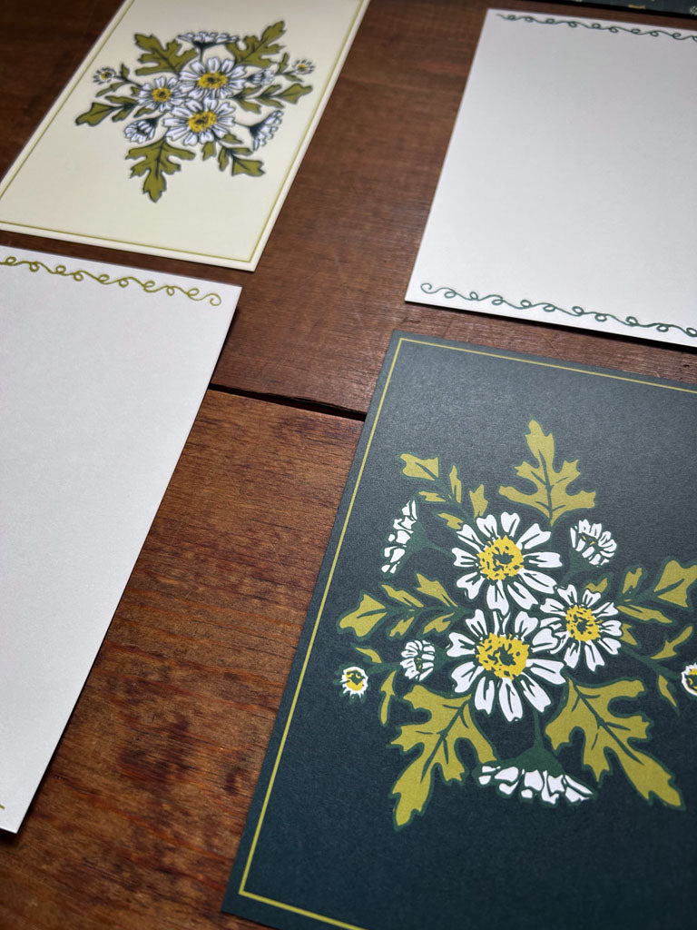 chamomile Floral-patterned cards on a wooden surface