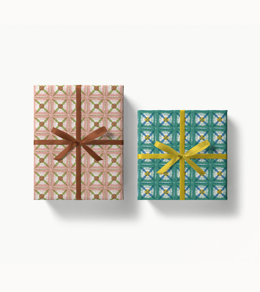 Two wrapped gift boxes with decorative dandelion patterned paper and ribbons on a white background