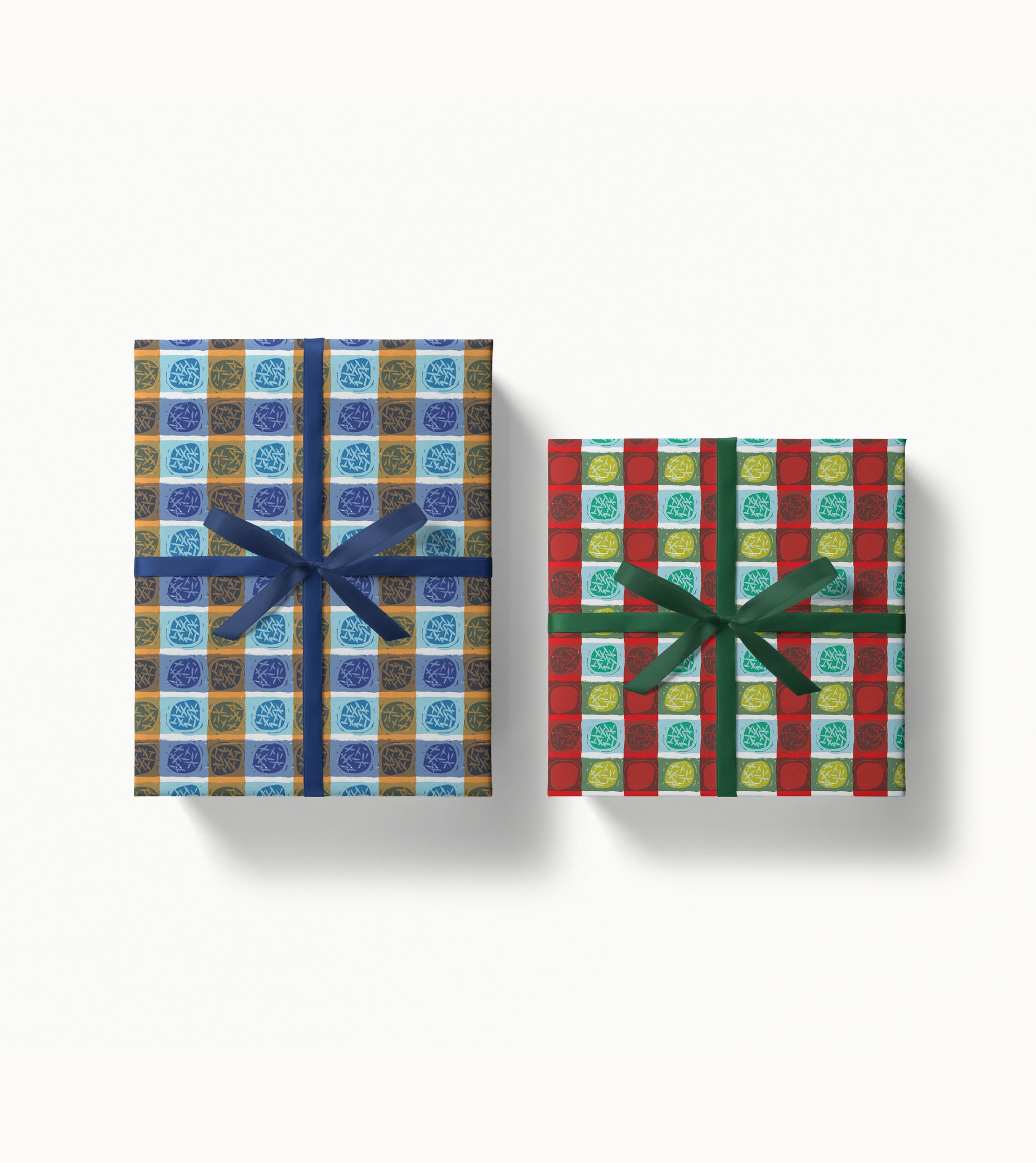 Two gift boxes with colorful dots and stripes patterns and ribbons on a white background