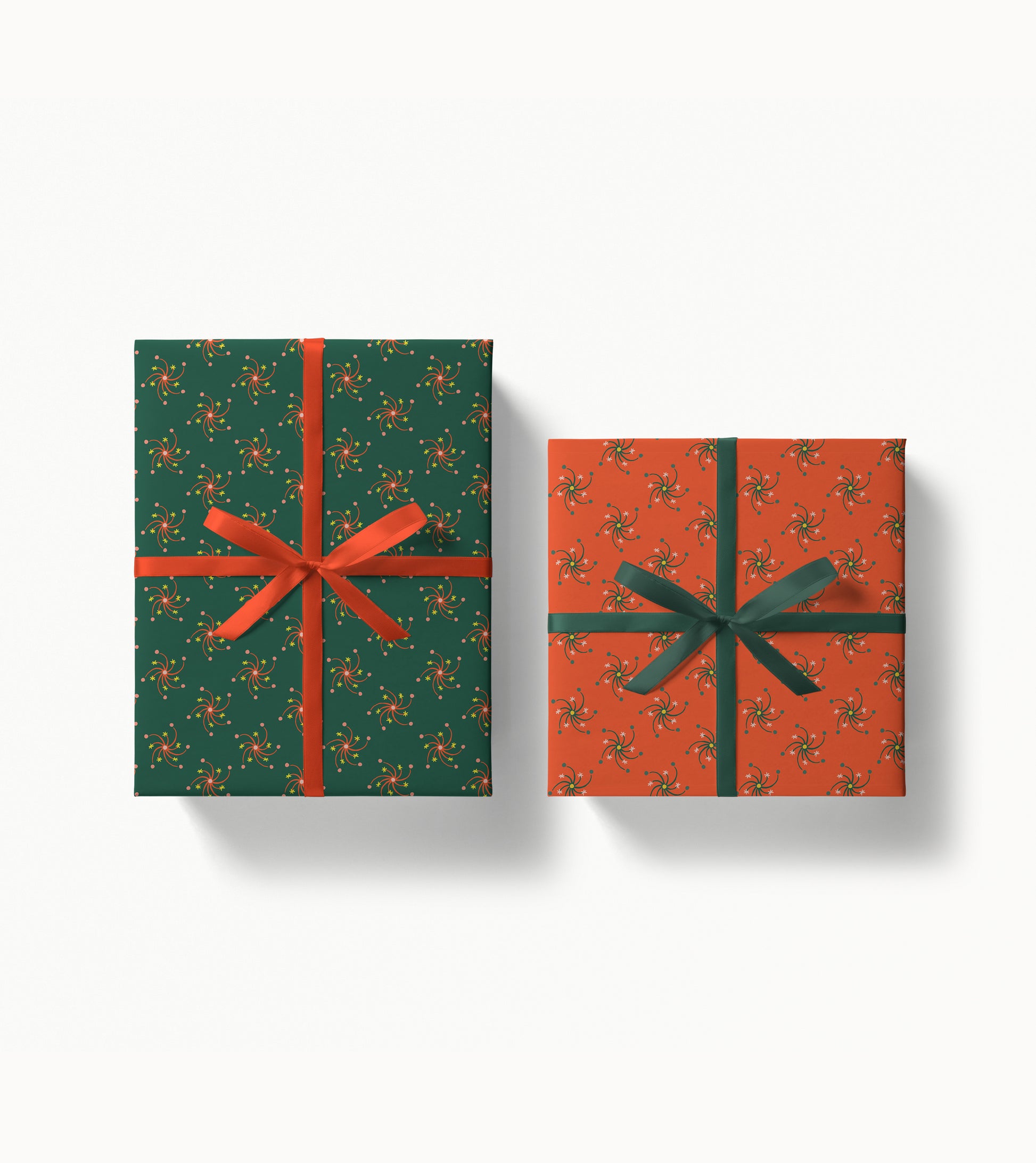 Two wrapped gift boxes with decorative patterned paper and ribbons on a white background