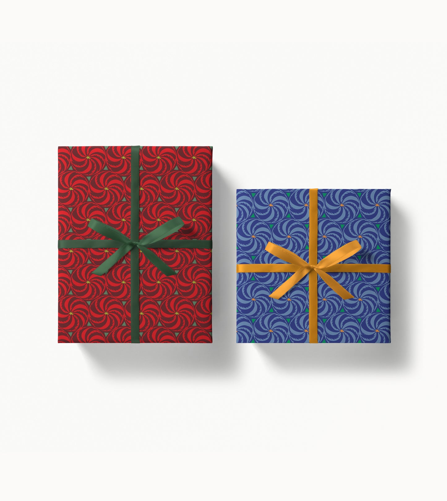 Two gift boxes wrapped in pinwheel patterned paper with decorative ribbons on a white background