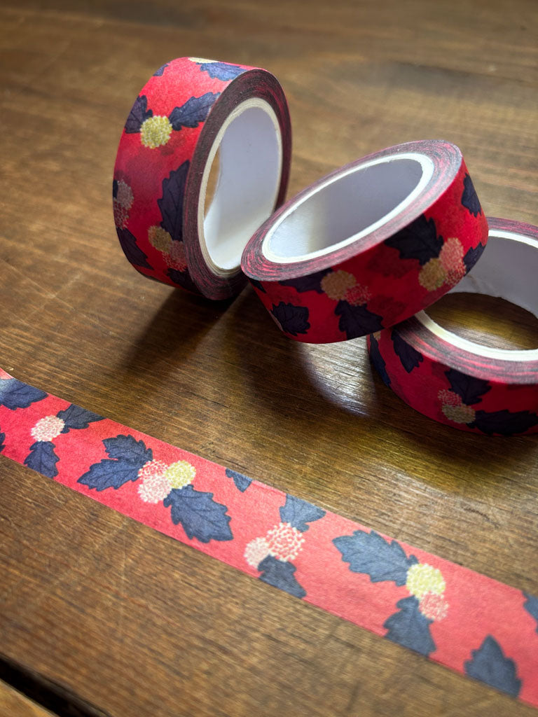 Decorative washi tape with floral pattern on a wooden surface