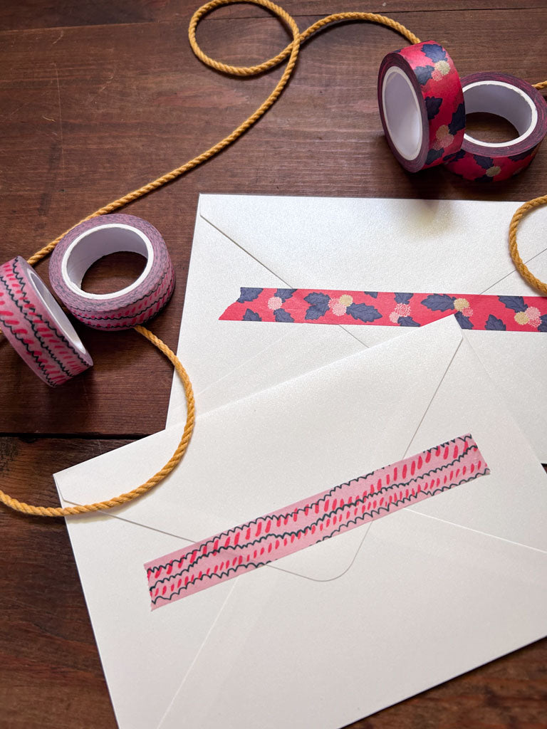 two Decorative washi tape designs with floral and scallop patterns on a wooden surface