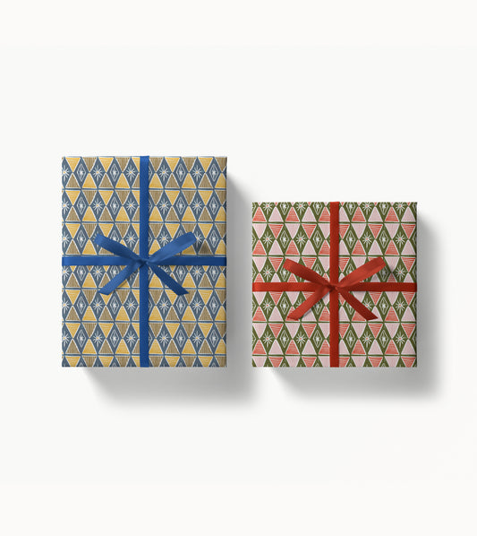 Two gift boxes with harlequin patterned wrapping paper and ribbons on a white background