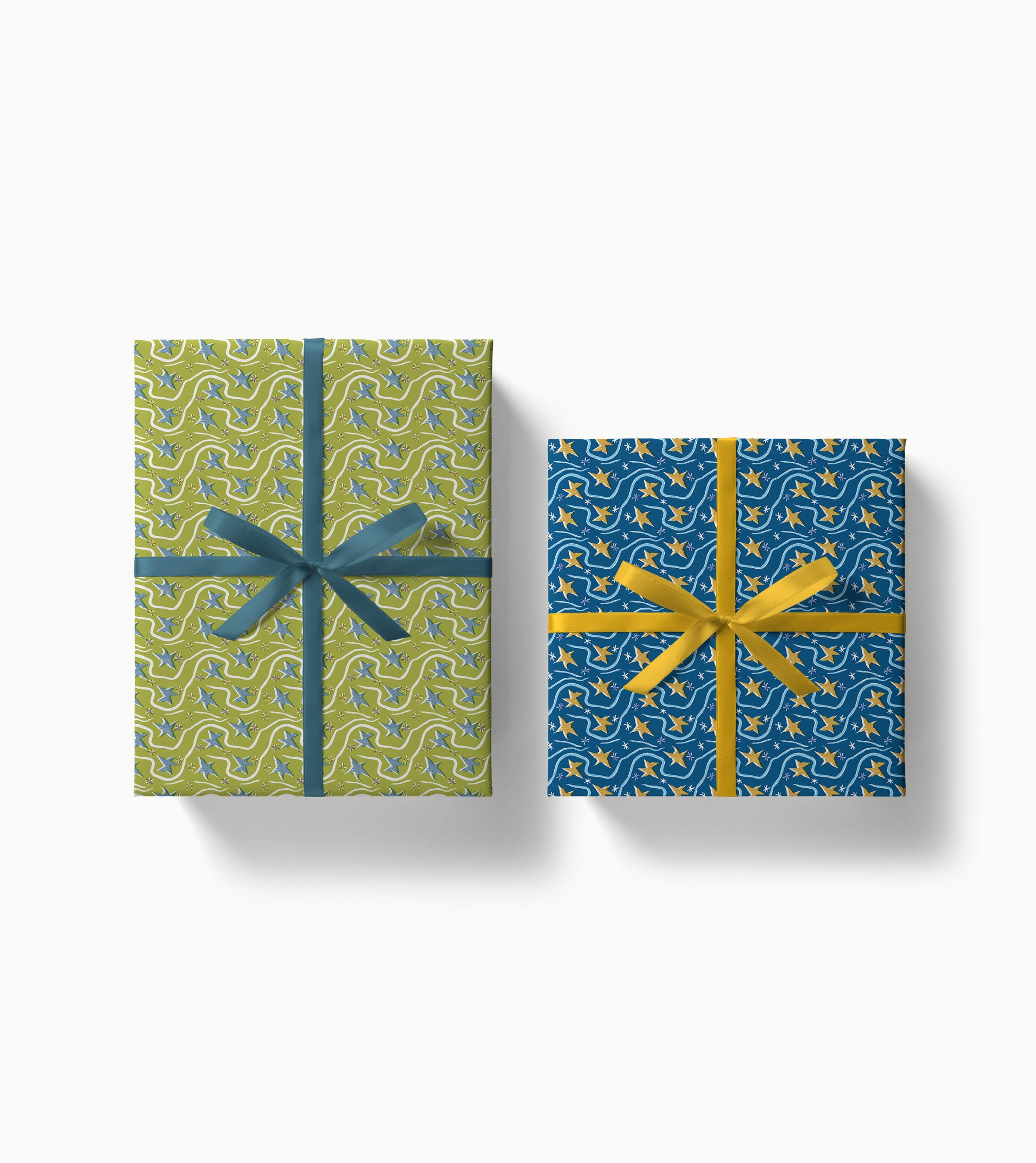 Two gift boxes wrapped with decorative patterned paper and ribbons on a white background