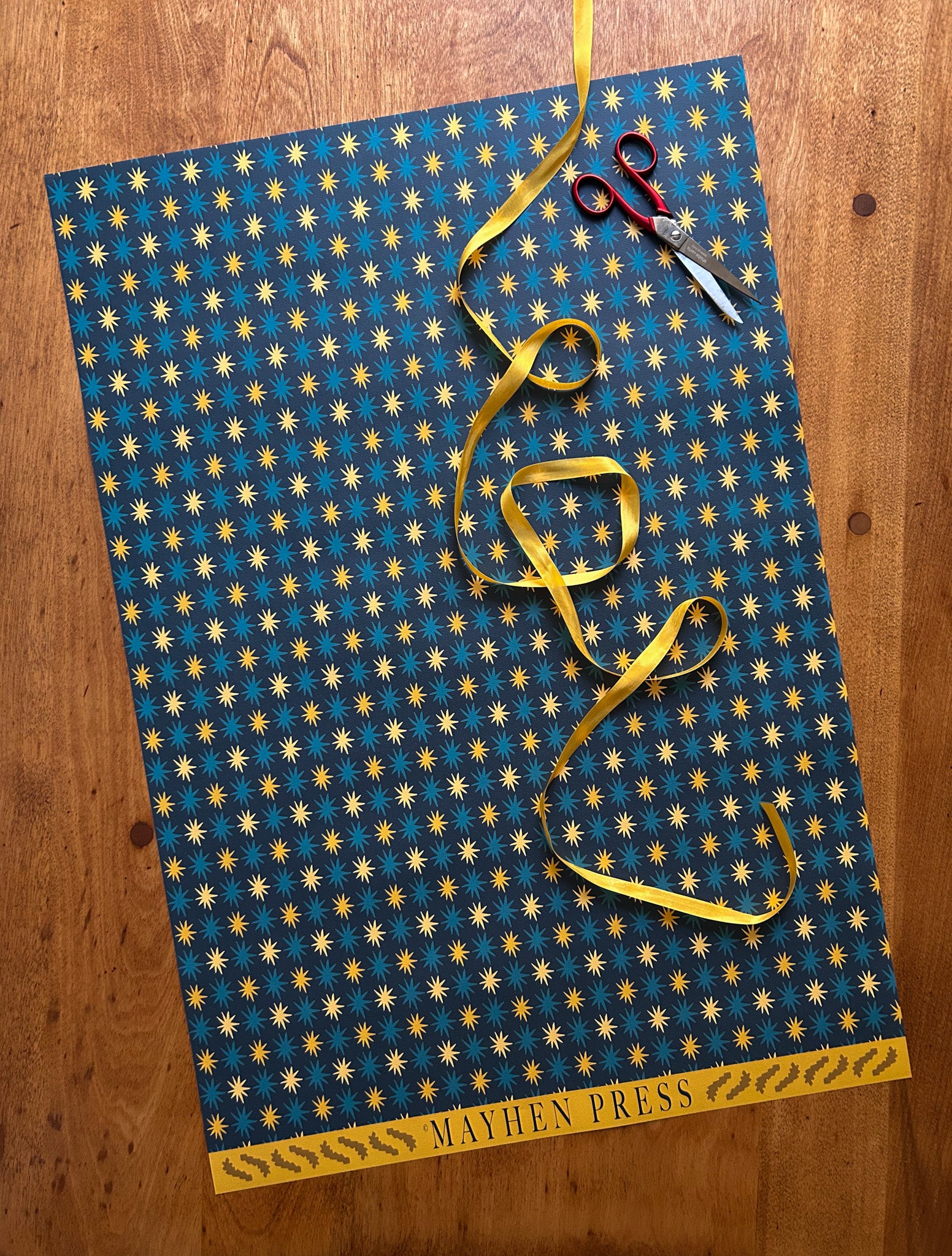 star patterned wrapping and crafting paper with a darker background and blue and yellow stars