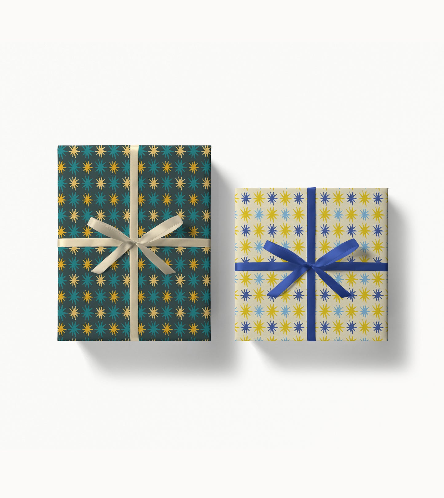 Two gift boxes with star-patterned wrapping paper and ribbon on a white background