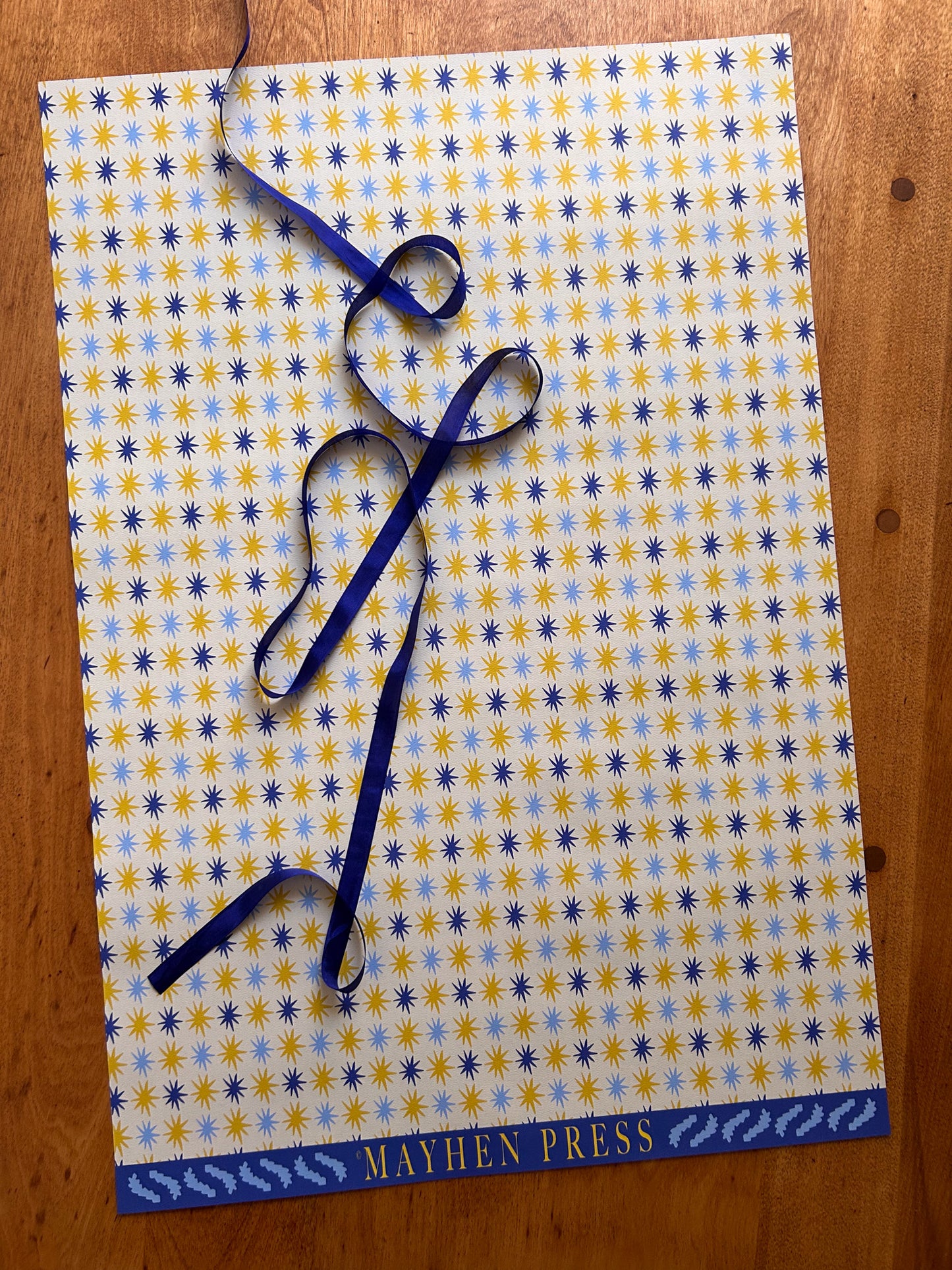 star patterned wrapping and crafting paper with a lighter background and blue and yellow stars