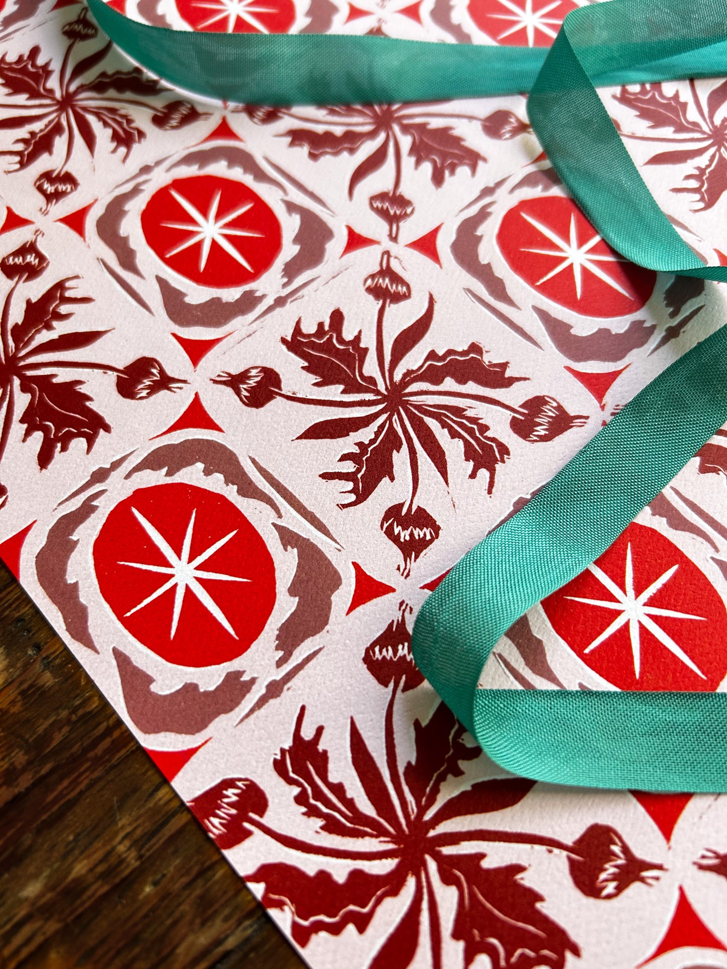 close up of buds and stars patterned crafting paper in red hues