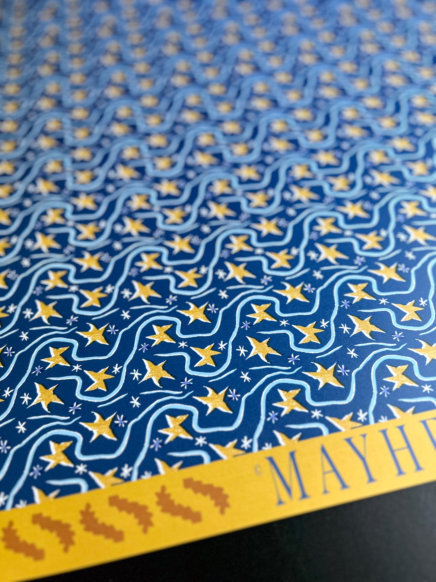 close up of shooting stars pattern crafting sheet featuring yellow stars on a blue background