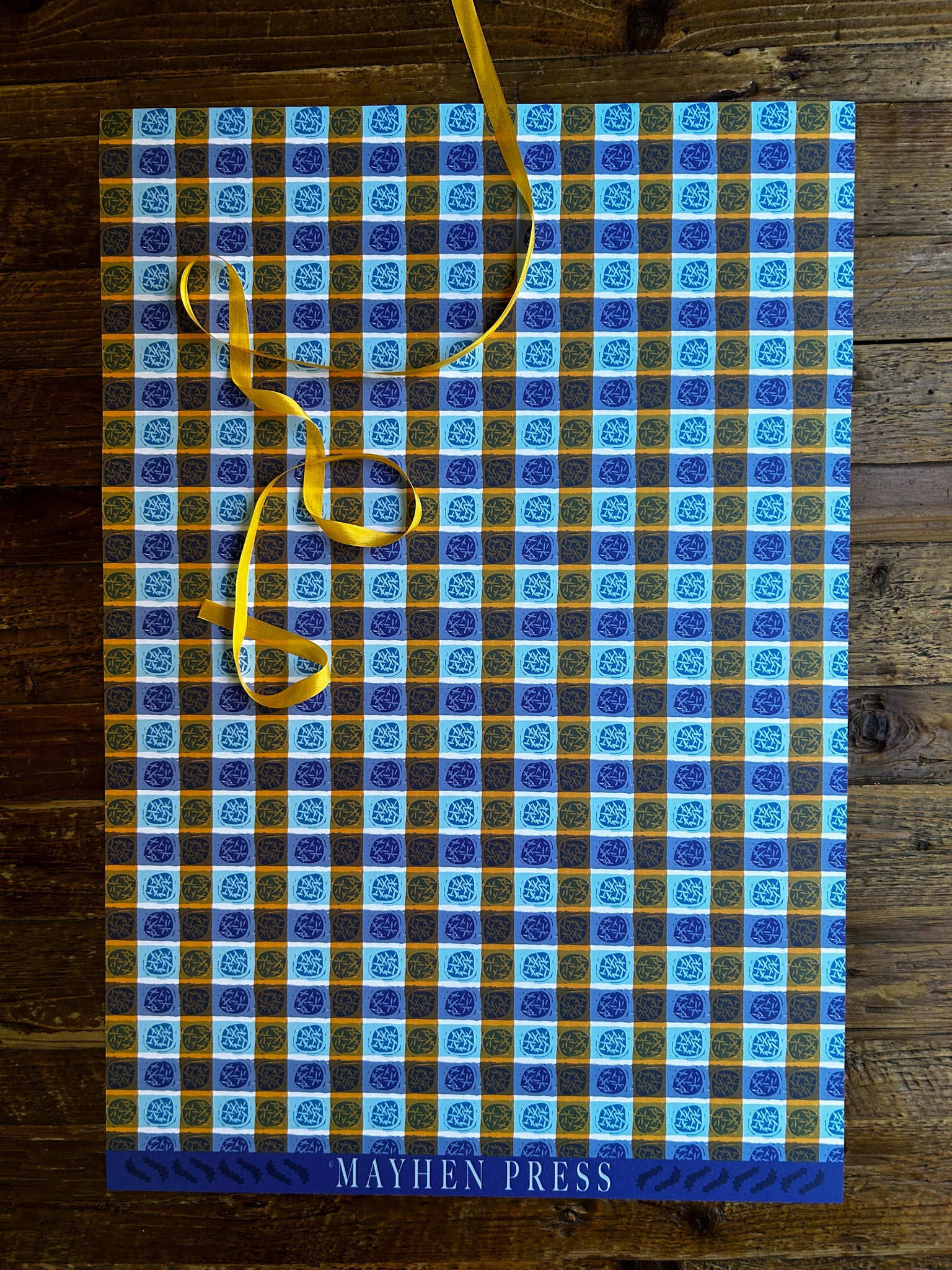 a dots and stripes patterned wrapping sheet featuring the 'Mayhen Press' branding on the bottom