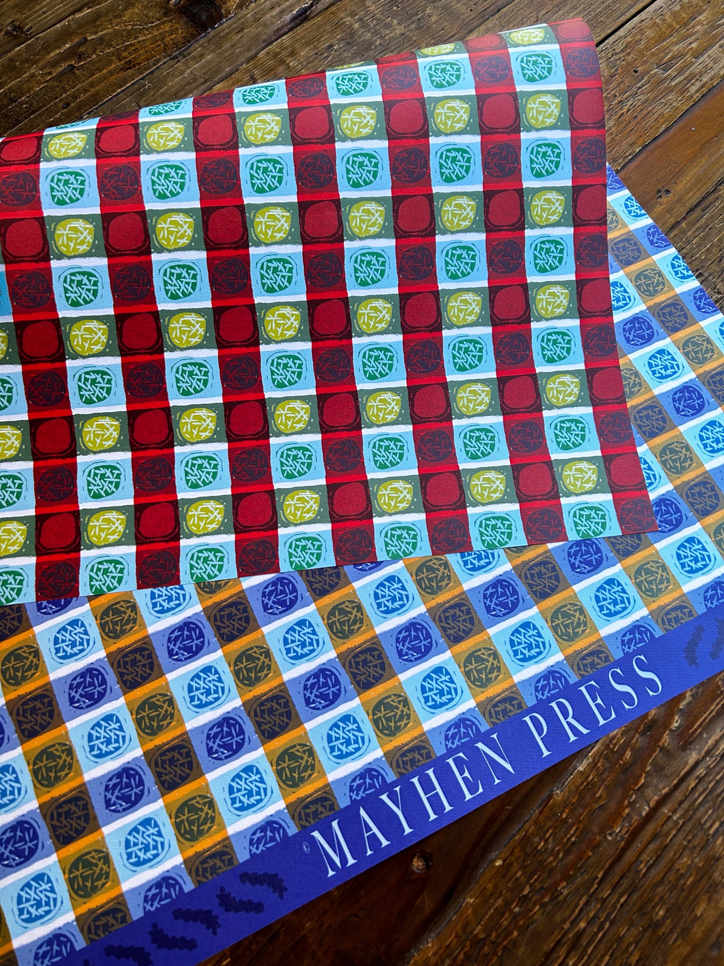 a double sided wrapping paper sheet with a dots and stripes pattern design in blue on one side and red on the other