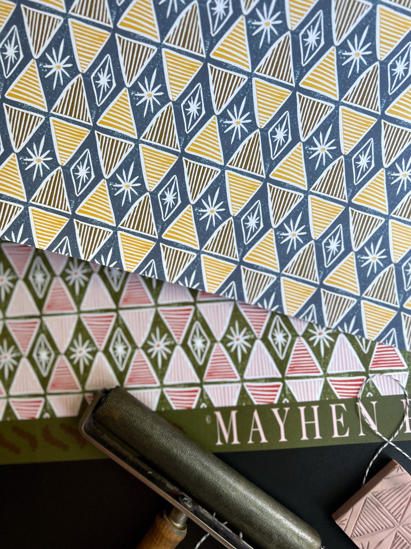double sided hand carved linocut crafting paper featuring a red and green colorway on one side and a blue and yellow on the other