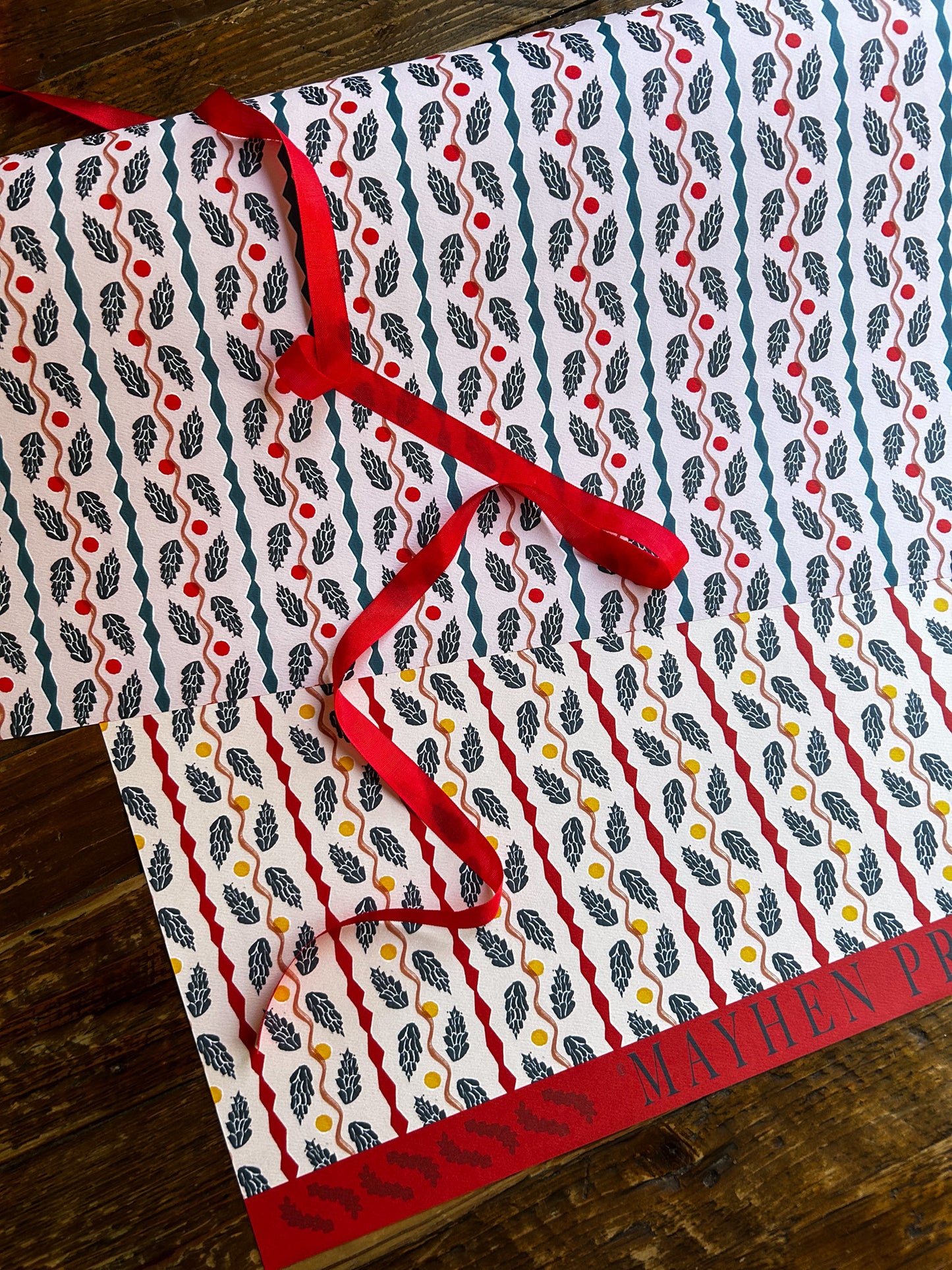 double sided artist designed wrapping and crafting paper featuring a unique pinecone panels pattern