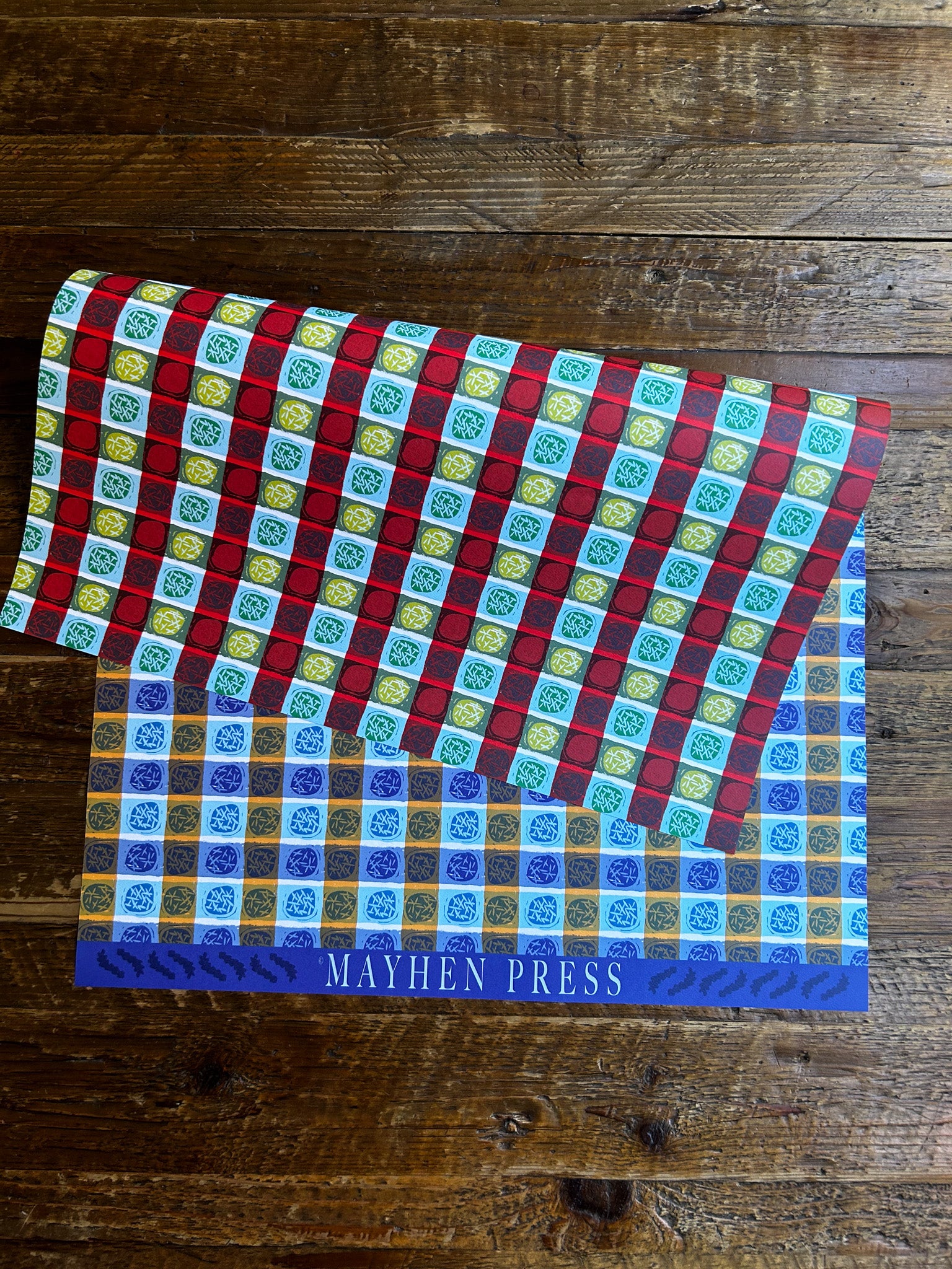 double sided wrapping paper sheet featuring a blue colorway on one side and red on the other with a dots and stripes pattern