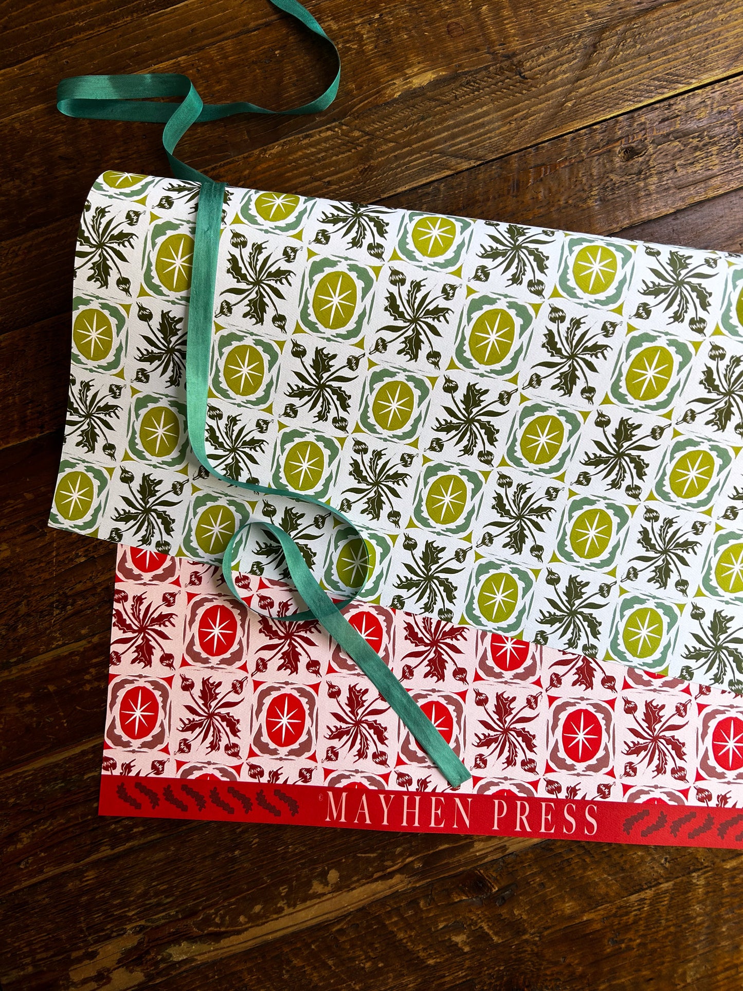 double sided wrapping paper with green and red floral and star pattern
