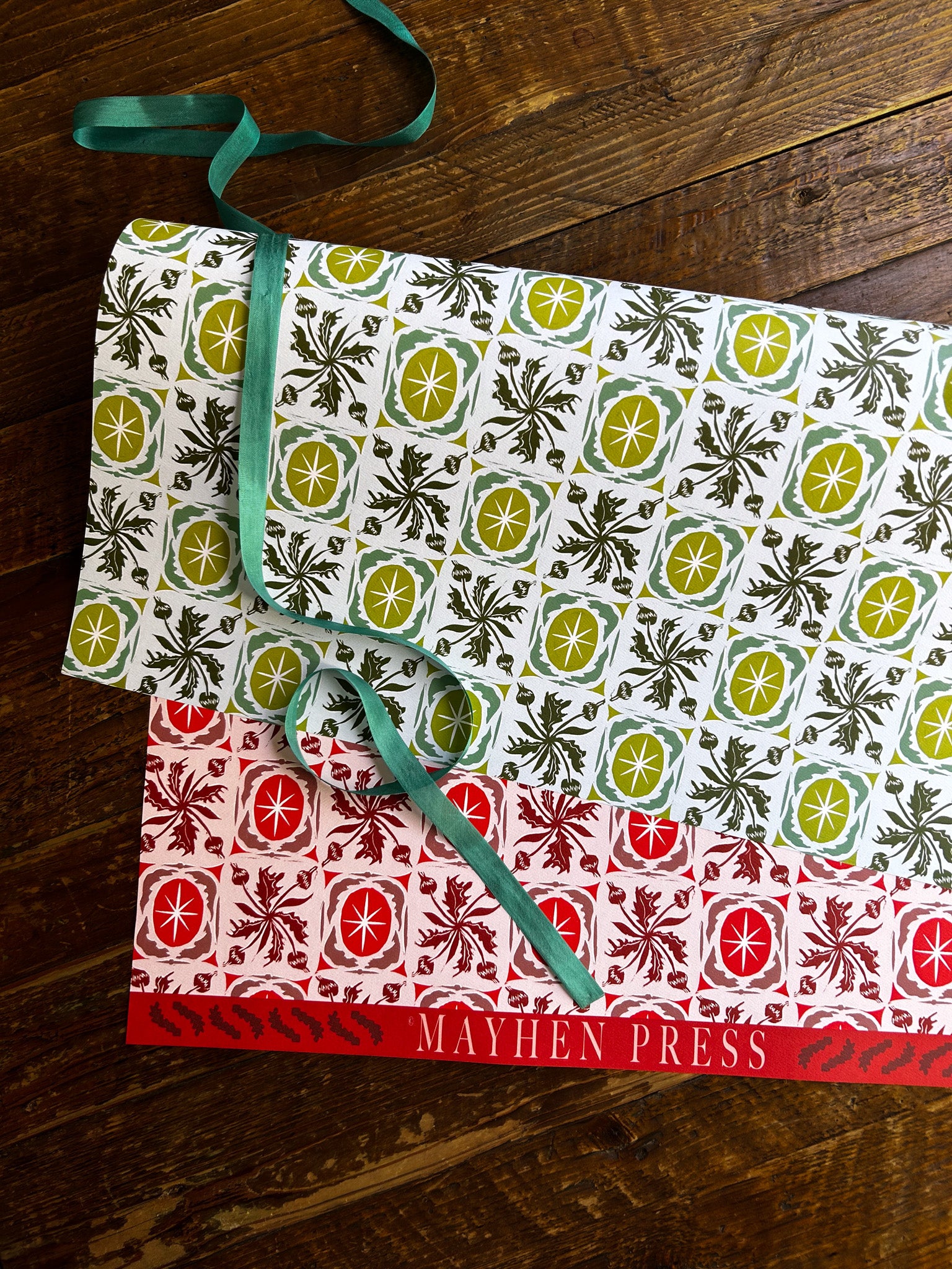 double sided wrapping paper with green and red floral and star pattern