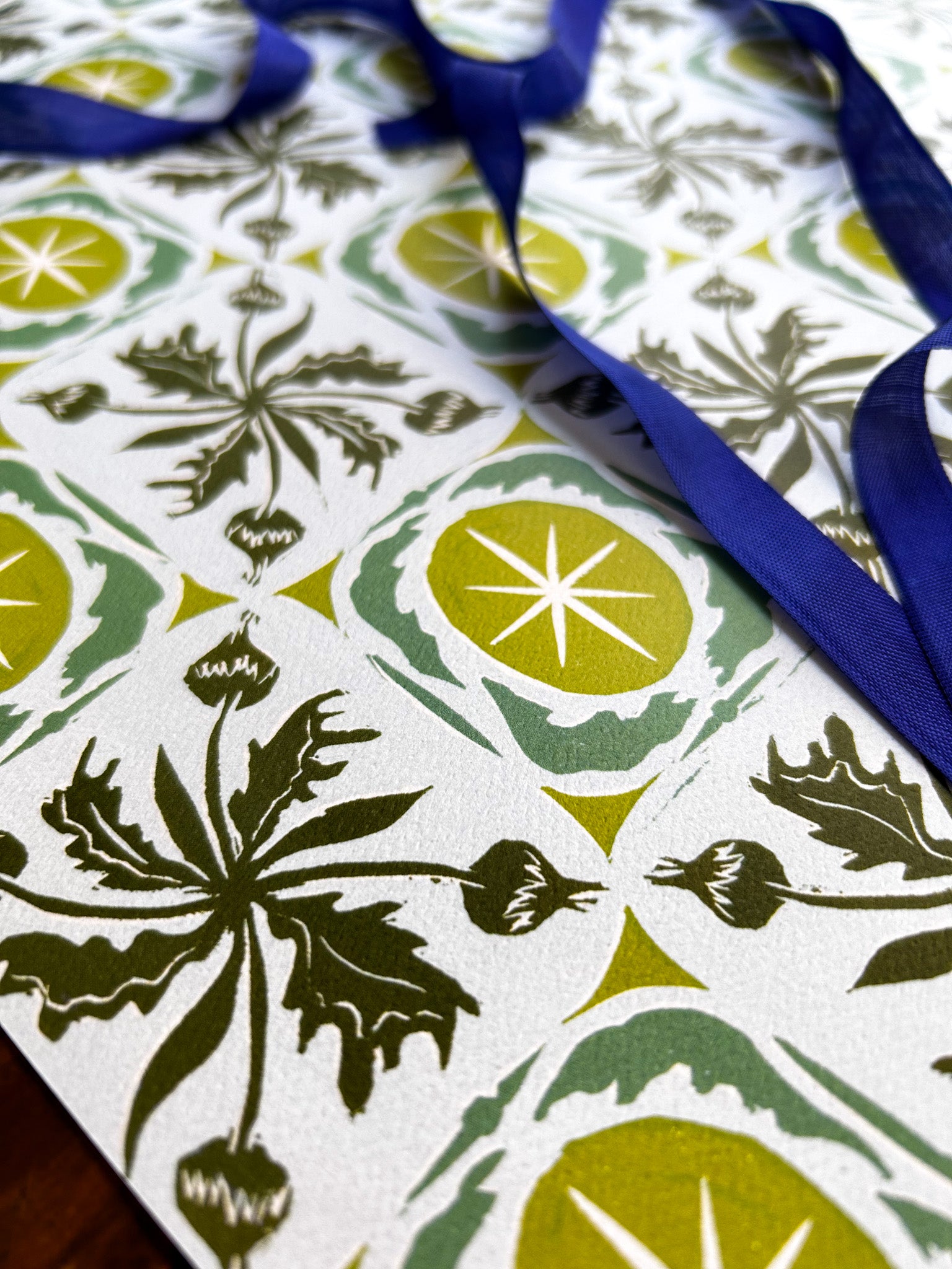 close up of buds and stars patterned crafting paper in green hues